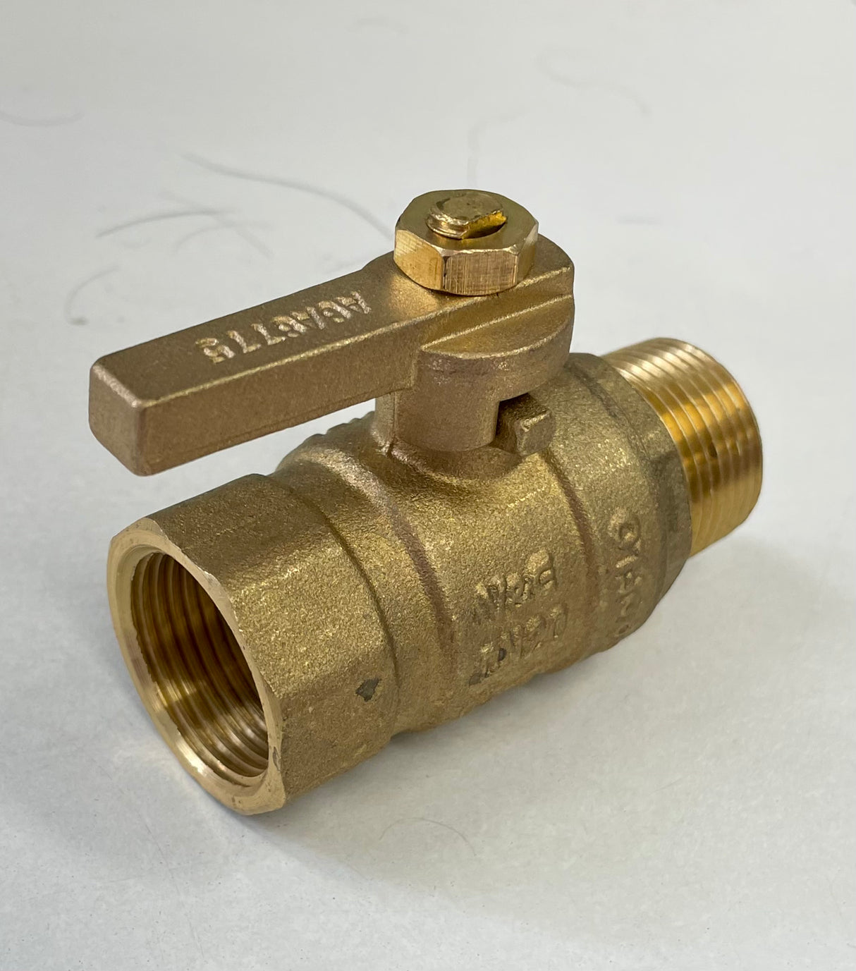 A brass ball valve with a male threaded end and a lever handle for turning the valve on and off.